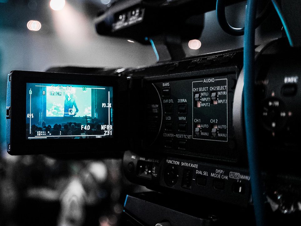 A video camera with the screen showing a man on it.