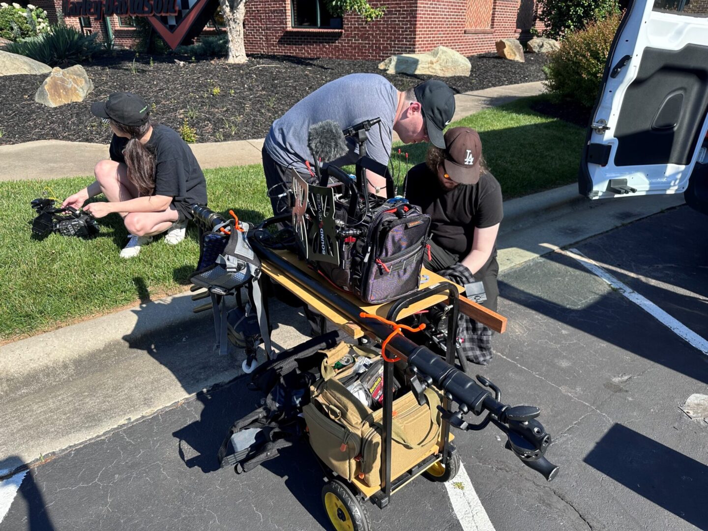 A man is working on some equipment in the street.