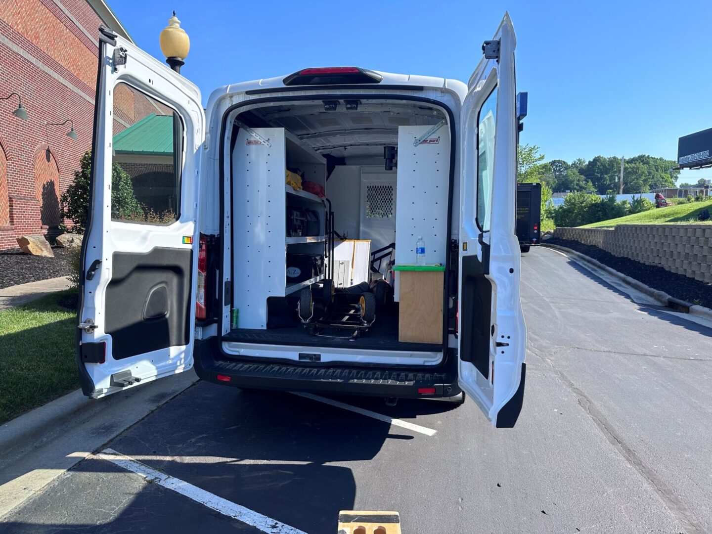 A van with the back door open and some boxes in it