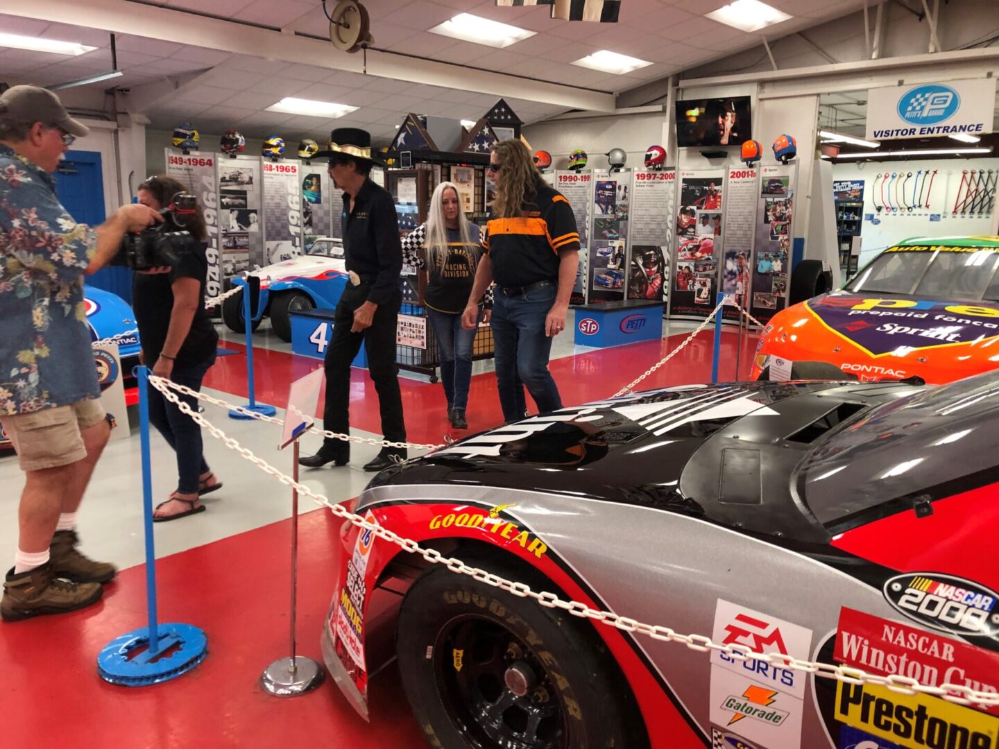 A group of people standing around a race car.