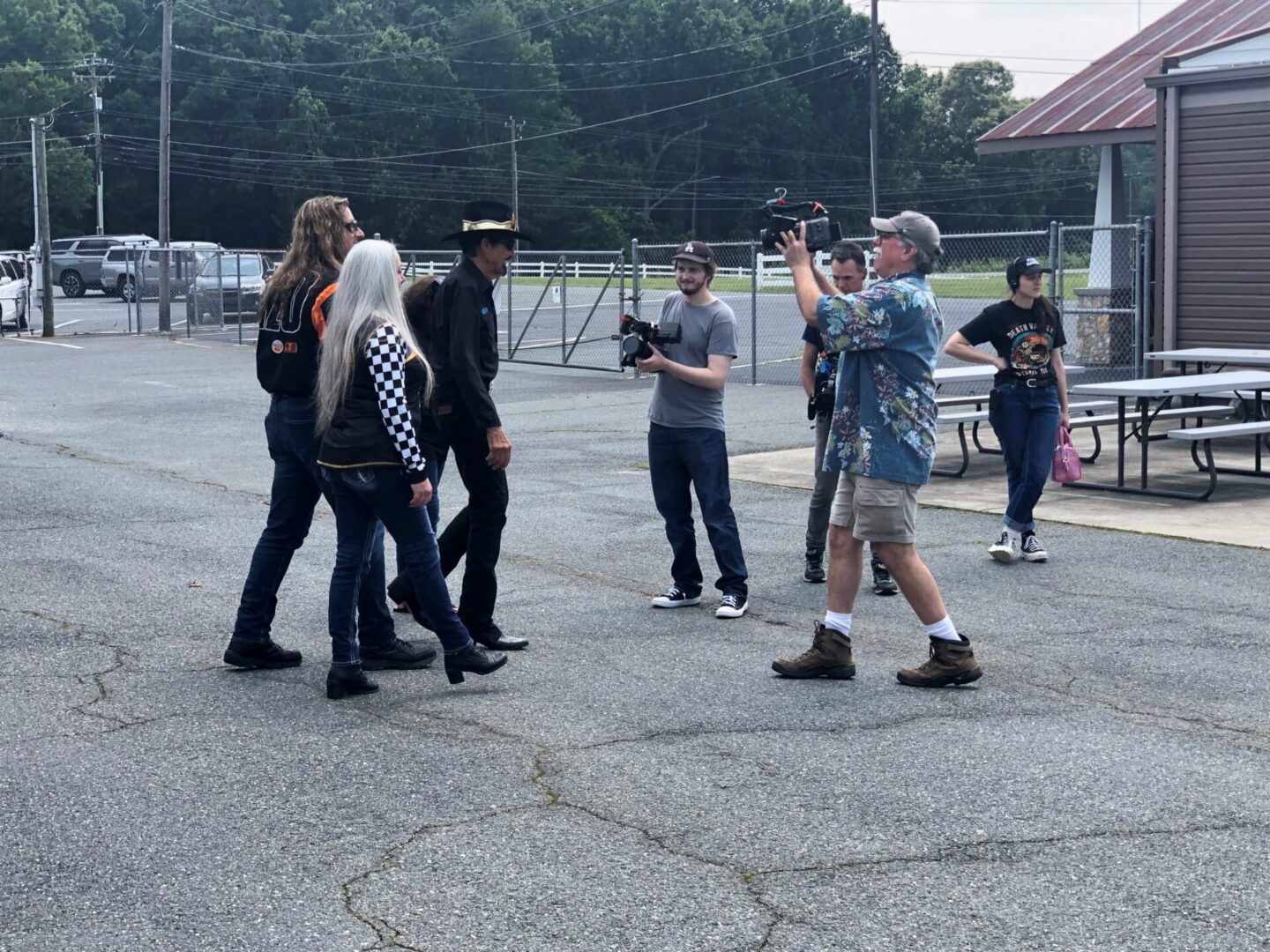 A group of people standing around in the street.